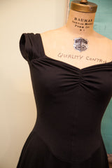 Ruched bodice and gathered cap sleeves of the black Betsey Johnson dress.