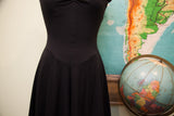Vintage Betsey Johnson black cotton dress with fitted waist and pleated skirt.