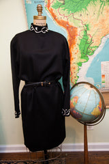 Lower section of the roomy vintage black Versace dress, showing white scalloped sleeve cuff.