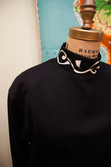 Vintage 80s Istante black dress, featuring the simple, well-made black fabric.