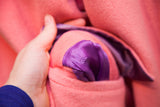 Versace Couture embroidered logo on the purple satin pocket lining of the pink wool coat.