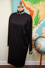 Full view of the roomy vintage 80s Versace black dress, white scalloped neck and cuffs.