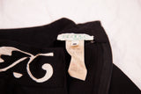 Istante Made in Italy label, white scalloped design, and black dress zipper detail.