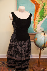 Fitted back of the black velvet vintage 50s top with scoop neck and patterned skirt.