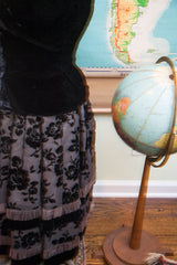Black velvet rose pattern and fringed hem of the vintage 50s dress skirt.