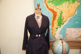 Collector's 1920s navy day dress featuring refined wrap design and Art Deco buckle.