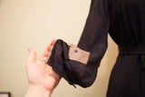 Vintage navy blue day dress sleeve cuff, showing buttons and light interior lining.