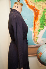 Navy blue 1920s day dress side view, showing Art Deco belt and delicate shoulder tears.