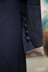 Vintage 1920s navy blue dress sleeve with black buttons and light brown cuff.