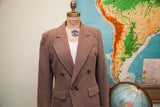 Brown herringbone wool blazer with double-breasted lapels and front buttons.