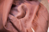 Sienna-brown lining detail of vintage blazer, showing inner seam wear.