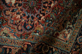 Hand-knotted pile and floral pattern of a vintage Heriz rug in brick red, navy, and powder blue.