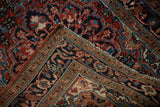 Folded corner revealing the dense hand-knotted foundation of a fine vintage Heriz rug.