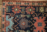 Antique Senneh rug with Harshang finned blossoms in navy, madder red, and teal.