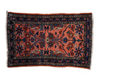 Hand-knotted vintage Lilihan rug with scrolling blossoms over a dusty blush field and a navy blue border.