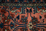 Scrolling blossoms in dusty teal and navy on the textured blush pile of a vintage Lilihan rug.