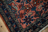 Intact side cord selvage on a vintage Lilihan rug with a navy blue floral border and blush field.