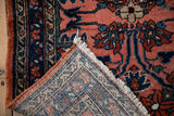 Corner view of a vintage Lilihan rug showing the hand-knotted back and secured selvage.