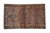 Vintage Persian Lilihan rug featuring an intricate millefleur design in dusty rose, sapphire blue, and sand.