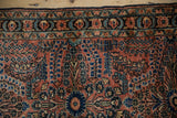 Vintage Lilihan rug border and field with dusty rose, sapphire, and sand millefleur motifs.