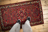 Quatrefoil center medallion of a vintage Hamadan rug with ruby, sapphire, and tangerine Herati motif.