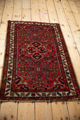 Vintage Hamadan rug with quatrefoil medallion, Herati motifs, ruby red and blue.