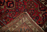 Rich red vintage Hamadan rug pile and its hand-knotted reverse foundation.