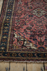Vibrant Herati design motif and germinating plant border in raspberry red and dusty teal.