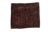 Fine German Sarouk square rug with a floral medallion in raspberry red and dark navy blue.