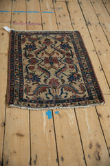 Antique Lilihan rug corner featuring heavy gauge machine binding and blue, red floral motifs on ivory.