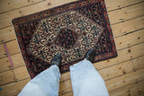 Vintage Senneh rug mat viewed from above to show its traditional Persian pattern and scale.