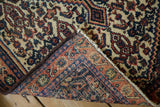 Heavy machine binding and dense, hand-knotted foundation of a vintage Persian Senneh rug.