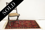Tight weave and restored cream fringe on a vintage Sarouk Persian rug's patterned border.