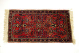 Bottom right corner of the vintage Sarouk rug, showing fine floral patterns and ivory fringe.