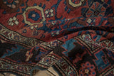 Nuanced gem-tone colors and floral motifs seen in the soft, dense pile of an antique Kurdish rug.