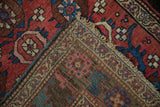 Corner detail of an antique Persian Bijar rug showing its tightly woven foundation and coarse selvage.