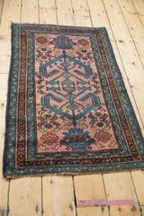 Antique Mehriban rug with geometric ram's horn vines in dusty raspberry and sapphire blue.