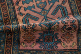 Geometric blossoms and pinwheels in sapphire and dusty teal on Antique Mehriban rug.