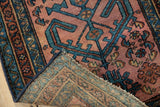 Antique Mehriban rug revealing hand-knotted foundation and dusty raspberry field with teal motifs.