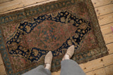Antique Malayer rug corner showcasing fine weave, dusty blush field, and botanical borders.