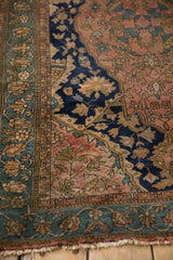 Antique Malayer rug detail: dusty blush field, navy floral motifs, slate border, worn fringe.