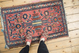 Hand-knotted Vintage Mehriban rug corner, pale raspberry field, navy serpent border, and tattered fringe.