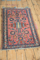 Vintage Mehriban rug with a pale raspberry field, navy blue serpent border, and floral motifs.