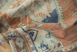 Textured vintage distressed Oushak rug showcasing terracotta, mint, and denim blue hues.