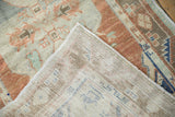 Distressed terracotta pile and visible hand-knotted foundation of this vintage Oushak runner.