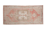 Vintage distressed Oushak runner with a center medallion in dusty red, coffee brown, and pale slate blue.