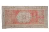 Vintage Oushak runner with a distressed floral medallion design in soft blush, rose, and silver tones.