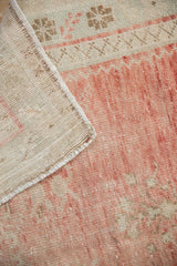 Close-up showing the hand-knotted foundation and secured side cord of a vintage Oushak rug.