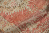 Vintage distressed Oushak runner texture with faded cherry red, ivory, and visible knot head wear.