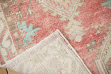 Vintage Oushak rug's hand-knotted foundation, distressed cherry red and turquoise pile.